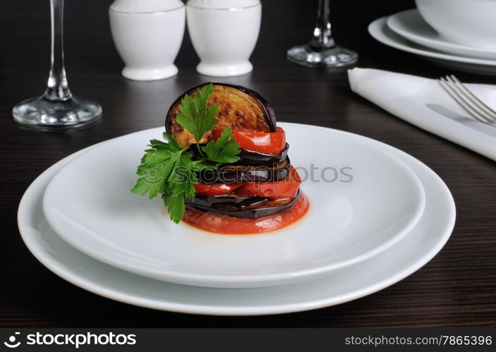 Appetizer of fried eggplant with tomatoes, parsley