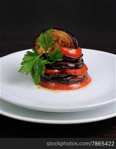 Appetizer of fried eggplant with tomatoes, parsley