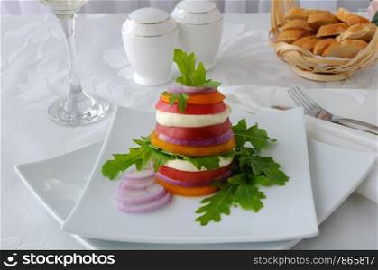 Appetizer of mozzarella with yellow and red tomatoes