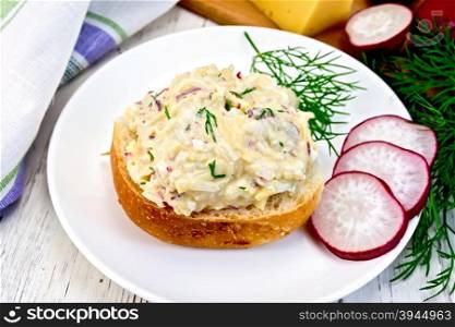 Appetizer of radish, dill, eggs and cheese on bread in white plate, a napkin on the background light wooden boards