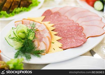 Appetizer. Plate of smoked meat or ham with cheese