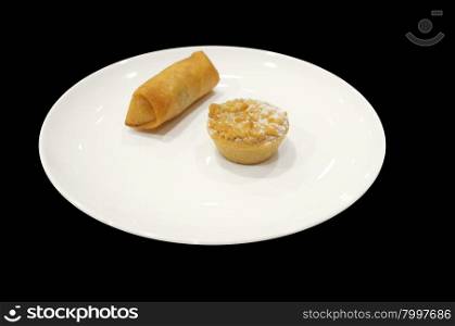 Appetizer sampler with spring roll and tart on white dish