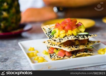 Appetizer with chips,tuna fish and fruits
