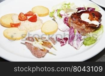 Appetizers of different kinds over white plate, horizontal image