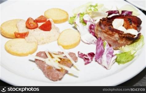 Appetizers of different kinds over white plate, horizontal image