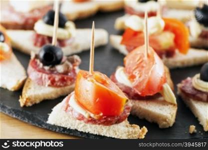 Appetizers over black stone plate, horizontal image