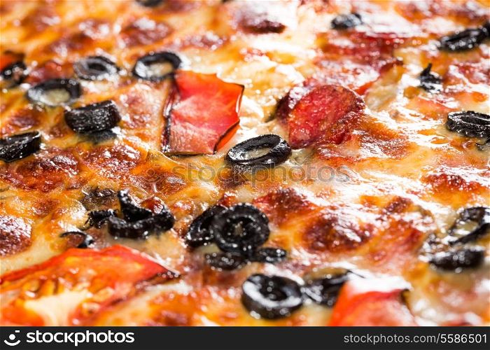 Appetizing background pizza closeup filling the frame.