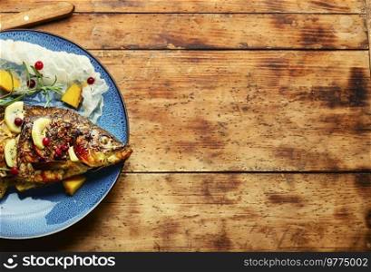 Appetizing baked fish in fruit marinade. Seafood, space for text. Fragrant grilled fish, copy space
