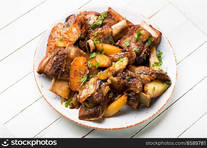 Appetizing beef ribs baked with potatoes. Braised beef stew. Beef stew with potatoes.