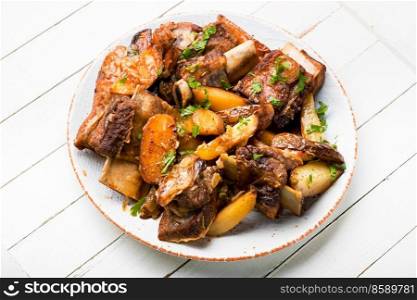 Appetizing beef ribs baked with potatoes. Braised beef stew. Beef stew with potatoes.