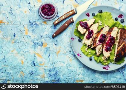 Appetizing chicken breast with huckleberry. Sliced grilled chicken meat.Copy space. Chicken breast with blueberry sauce,space for text