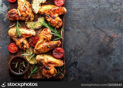 appetizing chicken wings grilled barbecue with spices and vegetables until crisp, top view, space for text. appetizing chicken wings grilled barbecue with spices and vegetables until crispappetizing chicken wings grilled barbecue with spices and vegetables until crisp, top view, space for text
