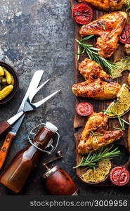 appetizing chicken wings grilled barbecue with spices and vegetables until crisp, top view, space for text. appetizing chicken wings grilled barbecue with spices and vegetables until crispappetizing chicken wings grilled barbecue with spices and vegetables until crisp, top view, space for text