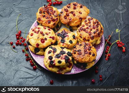 Appetizing cottage cheese pancakes or syrniki with summer berries. Cottage cheese fritters with red and black currants. Homemade syrniki with currants