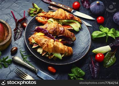Appetizing croissants,healthy breakfast.Croissants with trout, meat bacon, vegetables and fruits. Croissants or sandwich with meat and fish
