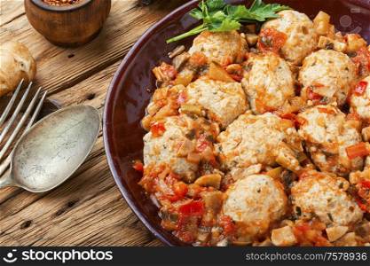 Appetizing dietetic rissole or meatball with vegetable sauce.Homemade cutlets. Meatballs in tomato sauce.