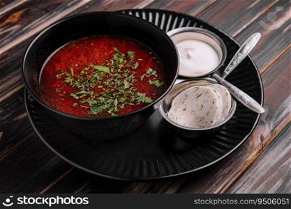 Appetizing dish borscht served with bread, lard slicrs and sour cream