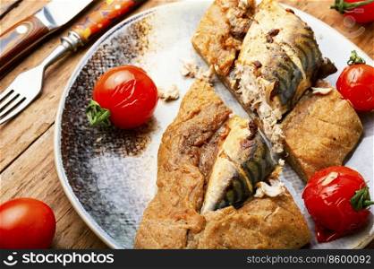 Appetizing food, mackerel baked in spicy dough. Seafood in dough. Tasty mackerel roasted in dough