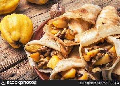 appetizing fruit pancakes. homemade pancakes stuffed with quince and walnut