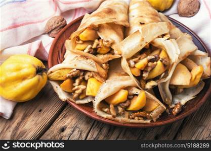 appetizing fruit pancakes. homemade pancakes stuffed with quince and walnut