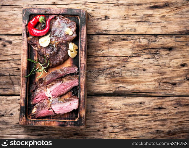 Appetizing grilled meat. Sliced meat steak on the kitchen board