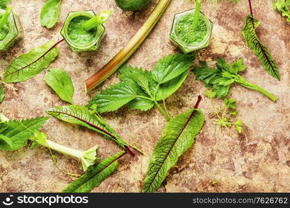 Appetizing healthy summer green smoothie from stalks of rhubarb and herbs.. Rhubarb and greens smoothie