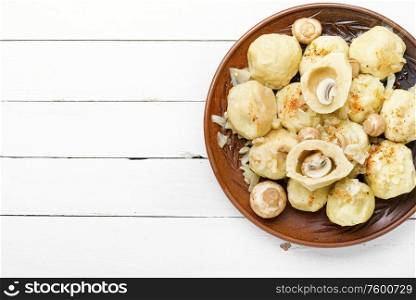 Appetizing homemade dumplings with mushroom filling on white background. Homemade varenyky with mushrooms.