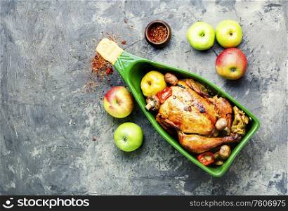 Appetizing homemade fried chicken with apples and mushrooms. Baked chicken with apples.