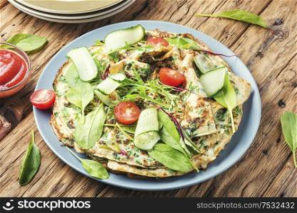 Appetizing homemade pancakes with spinach and arugula. Homemade pancakes with herbs