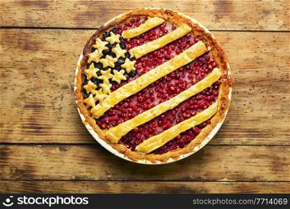 Appetizing homemade pie with red and black currants. Sweet dessert. American flag.American berry pie.. American berry pie.