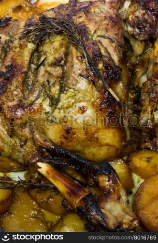 Appetizing homemade roast leg of lamb with potatoes and rosemary