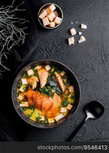 Appetizing ishikari miso soup with salmon in a black bowl
