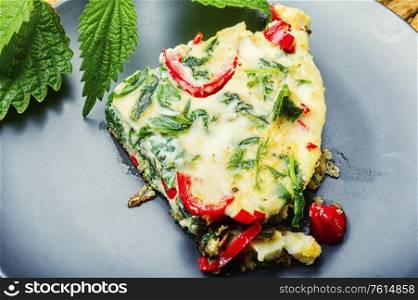 Appetizing Italian omelet with fresh herbs and nettles.Italian cuisine.Healthy eating. Italian omelet with nettle