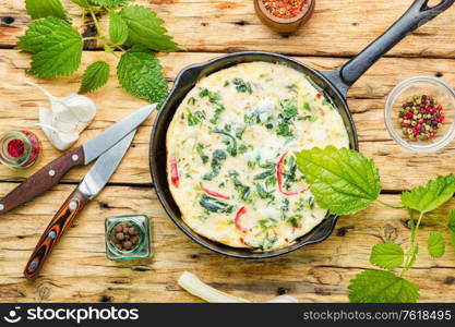 Appetizing Italian omelet with fresh herbs and nettles.Italian cuisine.. Italian omelet with herbs