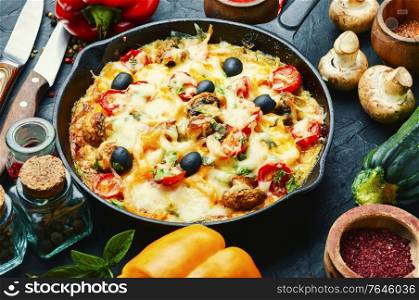 Appetizing Italian pizza with chicken breast, tomato,cheese and olives. Delicious pizza on concrete background