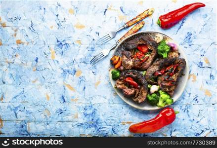 Appetizing meat baked with bell pepper and broccoli.Beef roll,meatloaf.Copy space. Roasted beef meat with vegetables,space for text