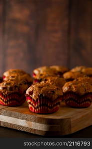 Appetizing muffins on a wooden cutting board. Traditional pastries for the holiday.. Muffins on a wooden cutting board. Traditional pastries for the holiday.