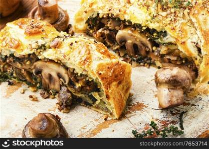 Appetizing mushroom pie or wellington mushroom. English cuisine. Sliced pie with mushrooms