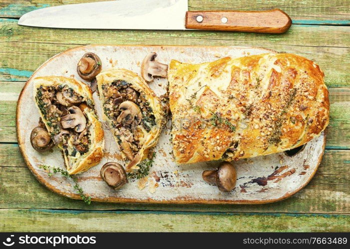 Appetizing mushroom pie or wellington mushroom. English home cooking.. Sliced pie with mushrooms