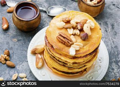 Appetizing pancakes with nuts and maple syrup.Pancake, breakfast. Pancakes with maple syrup.