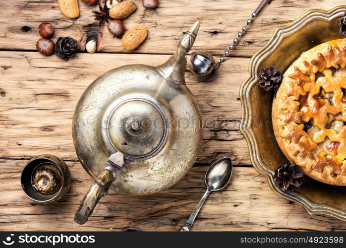 Appetizing pie for tea. Fashionable baked cake and kettle in oriental style
