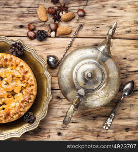 Appetizing pie for tea. Fashionable baked cake and kettle in oriental style