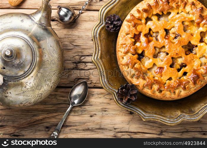 Appetizing pie for tea. Fashionable baked cake and kettle in oriental style