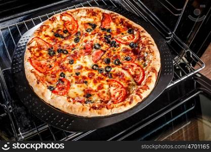 Appetizing pizza in the oven, Cooking in the oven.