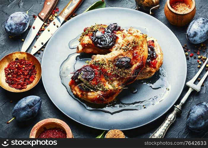 Appetizing pork steak cooked in plum sauce. Fried meat with plum