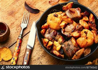 Appetizing pork stew with quince. Autumn recipe. Pork cooked with autumn quince.