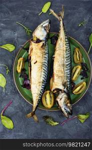 Appetizing prepared mackerel, scomber fish baked with kiwi pieces.. Grilled mackerel fish with kiwi