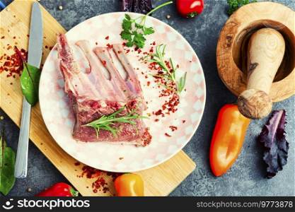 Appetizing raw lamb rib and spices on the kitchen table. Uncooked meat lamb. Raw lamb ribs for cooking