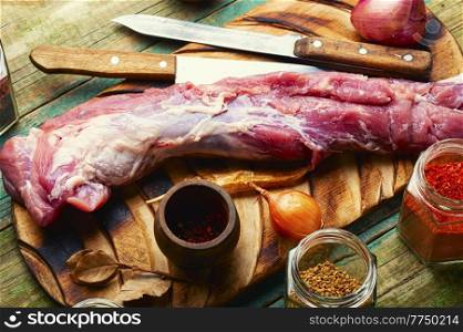 Appetizing raw pork meat for cooking. Raw meat and spices set. Uncooked pork tenderloin, fresh meat
