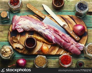 Appetizing raw pork meat for cooking. Raw meat tenderloin on cutting board. Uncooked pork meat, fresh meat